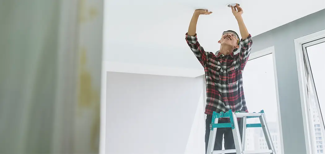 Worker installing light bulb